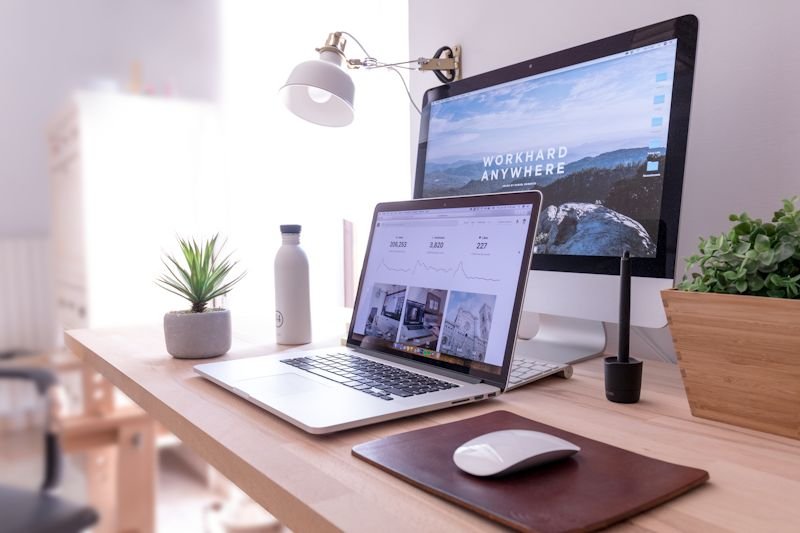 Tidy desk with a laptop and monitor ready for a video call